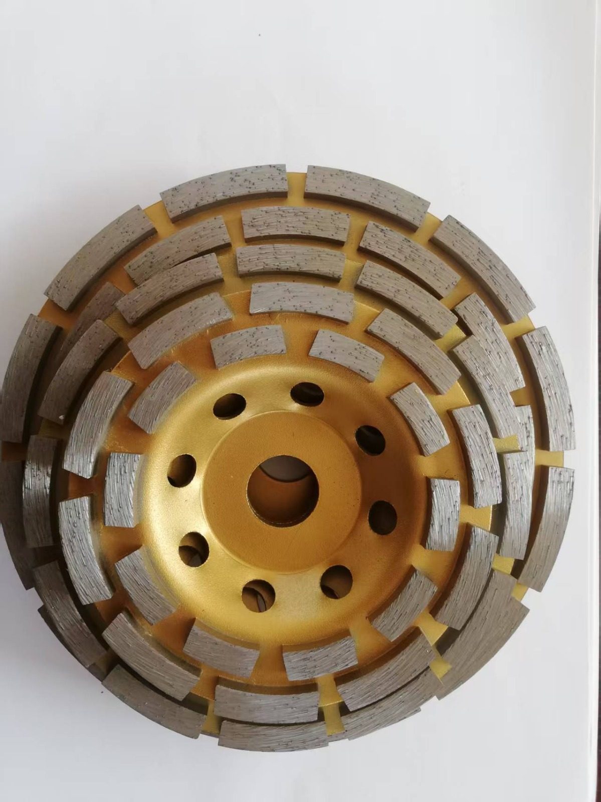 A round double-row diamond cup wheel, gold-painted with two concentric rings of diamond segments
